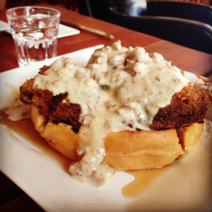 The chicken and waffles at Crema come topped with spicy sausage gravy.